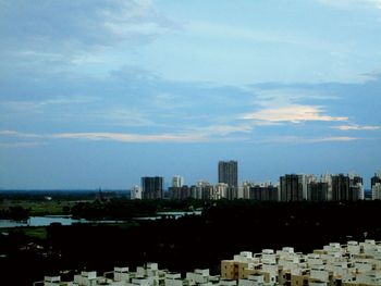 Cityscape against cloudy sky