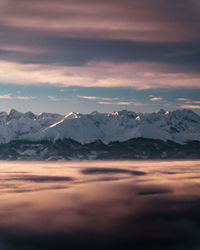 Scenic view of snowcapped mountains against sky during sunset