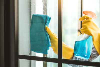 Close-up of clothes hanging on glass window