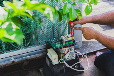 Electrical engineer checking circuit board at home.