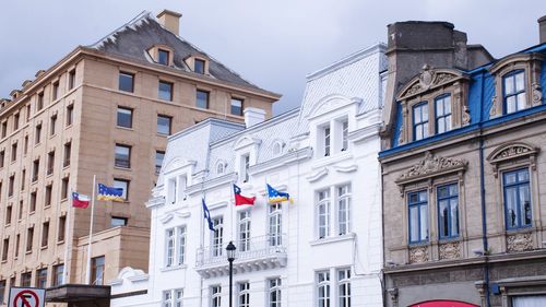 Low angle view of buildings in town against sky