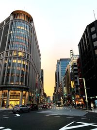 View of city street and buildings against sky