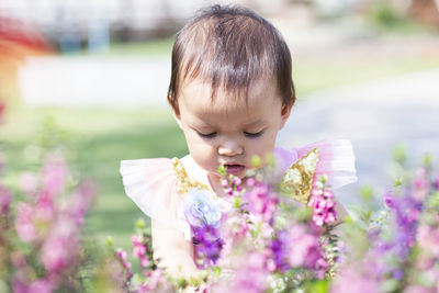 Cute boy on purple flowering plants