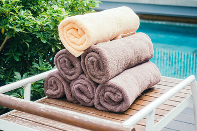 Stacked towels on table at poolside