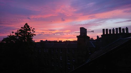 Silhouette buildings against sky during sunset