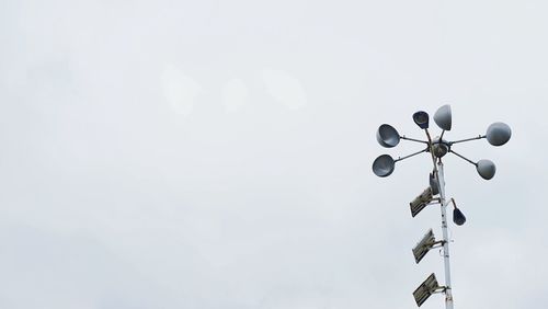 Low angle view of telephone pole against sky