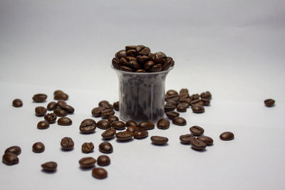 Close-up of roasted coffee beans against white background