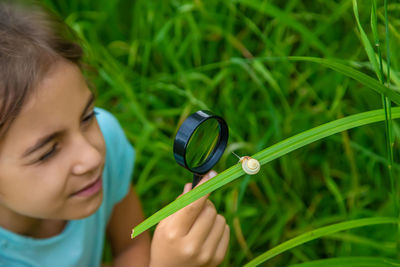 Close-up of boy holding magnifying glass