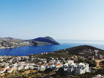 High angle view of townscape by sea against clear sky