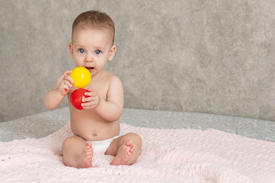 Portrait of cute baby boy with balloons