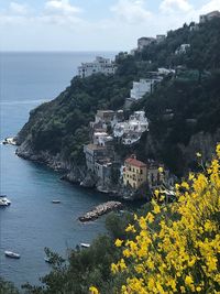 High angle view of buildings by sea against sky