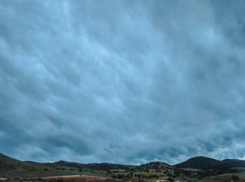 Scenic view of mountain against cloudy sky