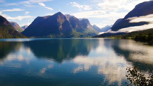 Scenic view of lake and mountains against sky