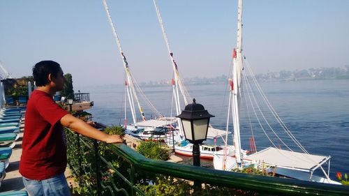 Young man looking at sea while standing on observation point