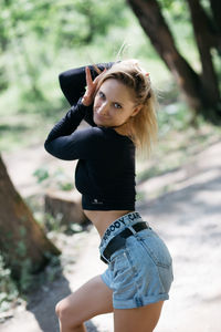 Young woman wearing hat while standing on land