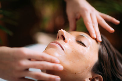 Beauty face mask on womans face in salon.