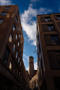 Low angle view of buildings against cloudy sky