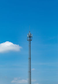 Low angle view of communications tower against blue sky