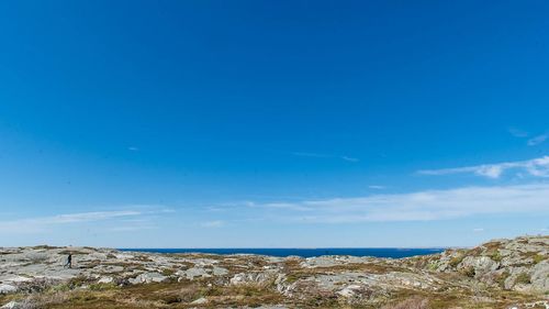 Scenic view of sea against blue sky