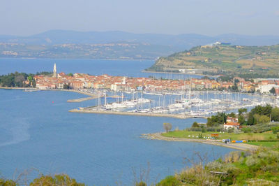 High angle view of townscape and harbor at sea