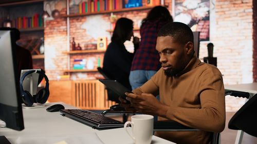 Side view of man using laptop while sitting at home