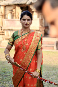 Portrait of young woman standing in traditional clothing