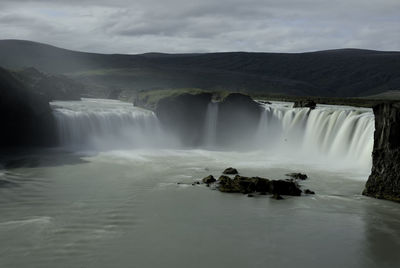 Scenic view of waterfall godafoss against sky