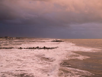 Scenic view of sea against dramatic sky