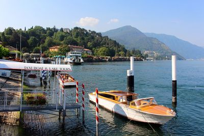 Water taxi anchored by jetty for lake tour