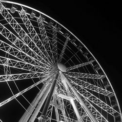 Low angle view of ferris wheel at night