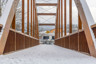 Snow covered field by building during winter
