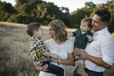 Happy family standing on field