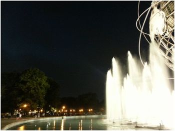 Illuminated fountain at night