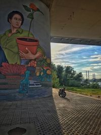 Full length of woman riding bicycle against sky