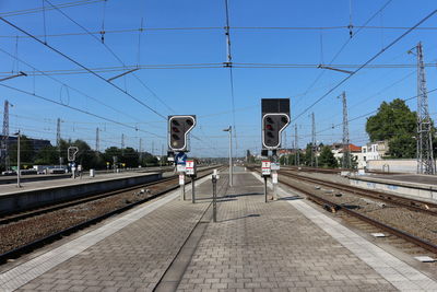 Railroad station platform against clear blue sky