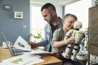 Friends and son on table