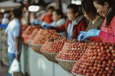 Vendors selling strawberries at market