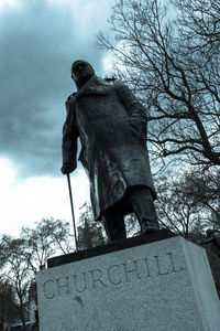 Low angle view of statue against cloudy sky