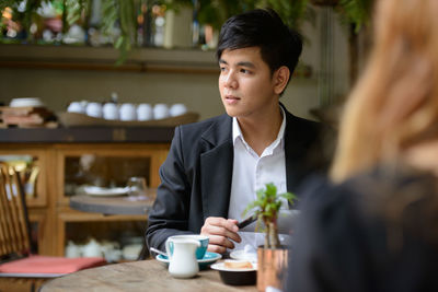 Young man sitting at table