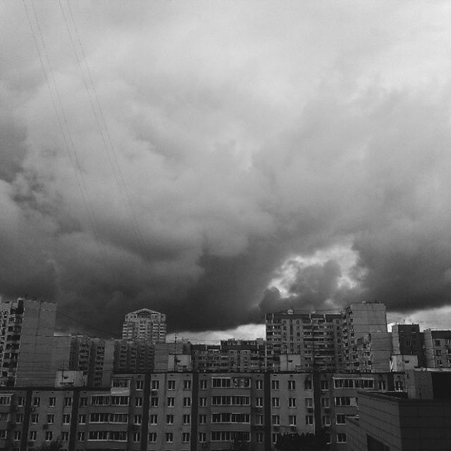 building exterior, architecture, built structure, sky, cloud - sky, city, cloudy, weather, overcast, residential building, cityscape, residential structure, storm cloud, low angle view, residential district, building, cloud, outdoors, no people, dusk