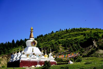 Low angle view of temple against clear blue sky