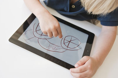 Boy drawing on digital tablet