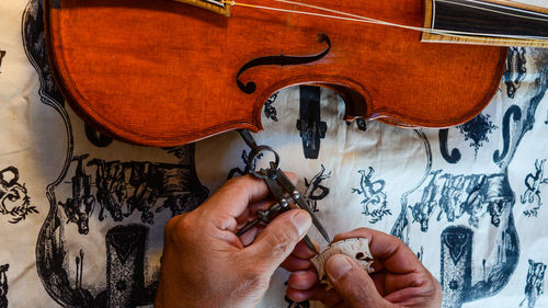 Violin violin maker luthier changing bridge of a handmade baroque viol