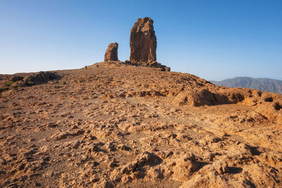 Rock formations on landscape against clear sky