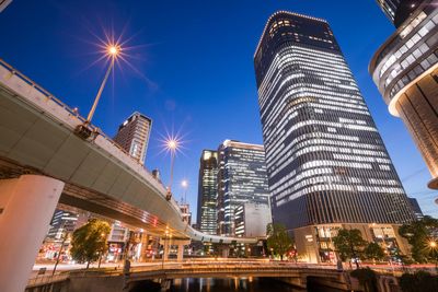 Low angle view of illuminated buildings against sky