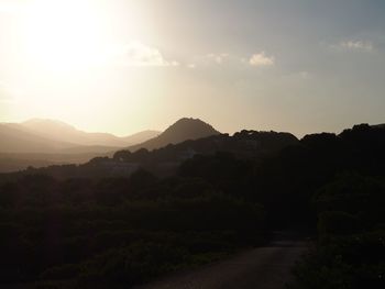 Scenic view of silhouette mountains against sky during sunset