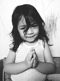 Portrait of cute girl sitting in front of woman