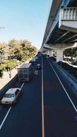 Cars on road against sky in city