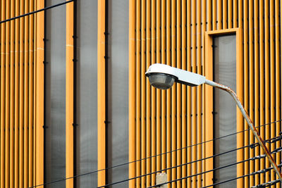 Low angle view of street light against building