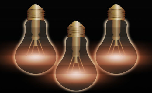 Digital composite image of light bulb against black background